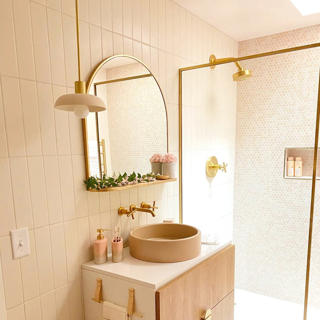 pink bathroom sink, mirror, and shower