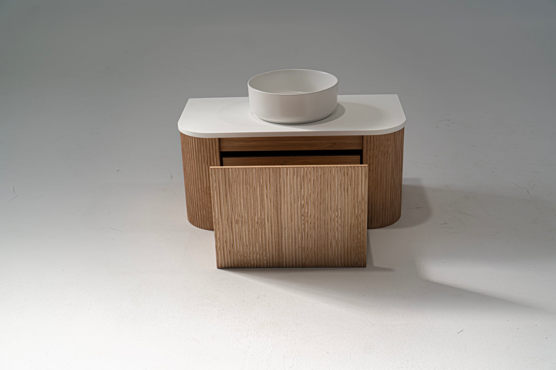 Portofino Oak Flute Vanity Unit with a white solid surface benchtop and a matte white ceramic basin, featuring a wood grain finish and a modern design.